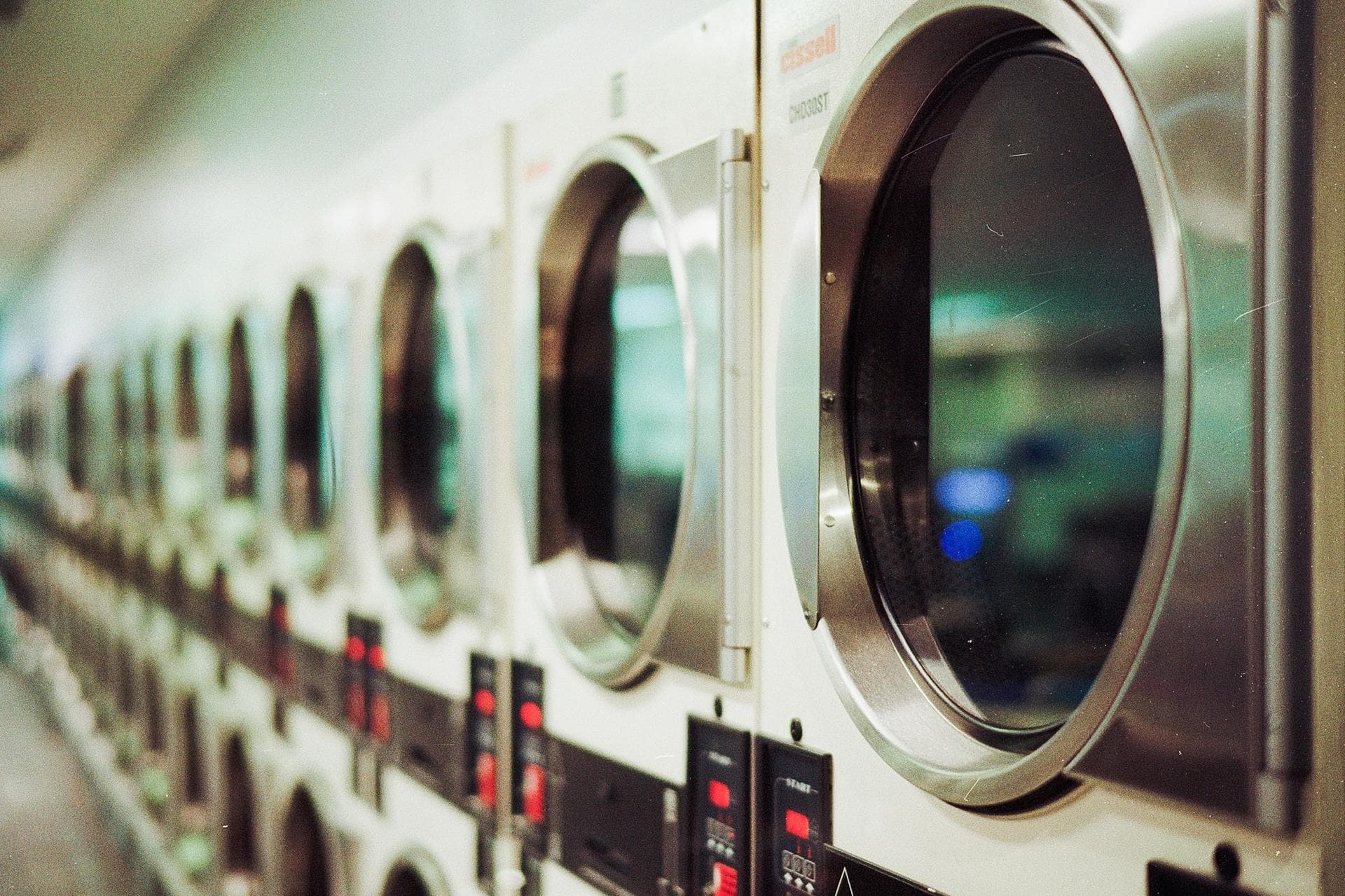 Commercial laundry room with a bank of dryers